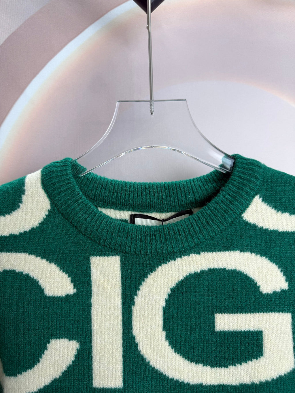 Long-sleeve knit sweater neckline, green with cream logo lettering