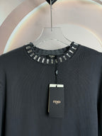 Dark gray sweater neckline with studded trim and short button placket