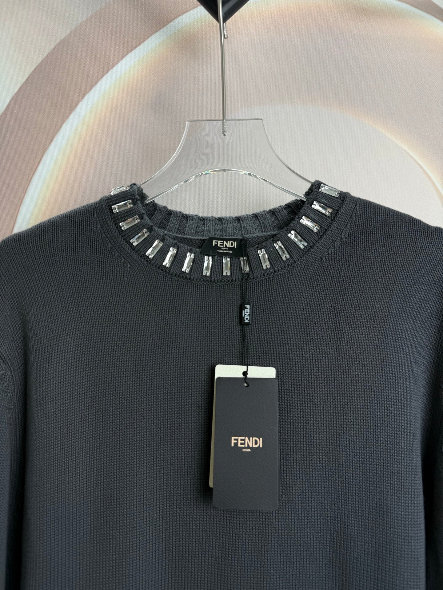 Dark gray sweater neckline with studded trim and short button placket