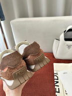 Brown and pink sneakers with FENDI logo on heel and thick beige platform sole.