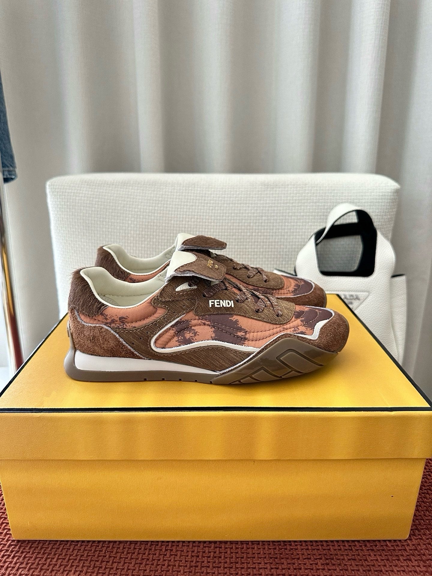 Brown and pink patterned lace-up sneakers with lace-up front and white sole.
