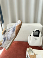 Fendi unisex sneakers shown from side, light blue-gray fabric with tan suede heel patch