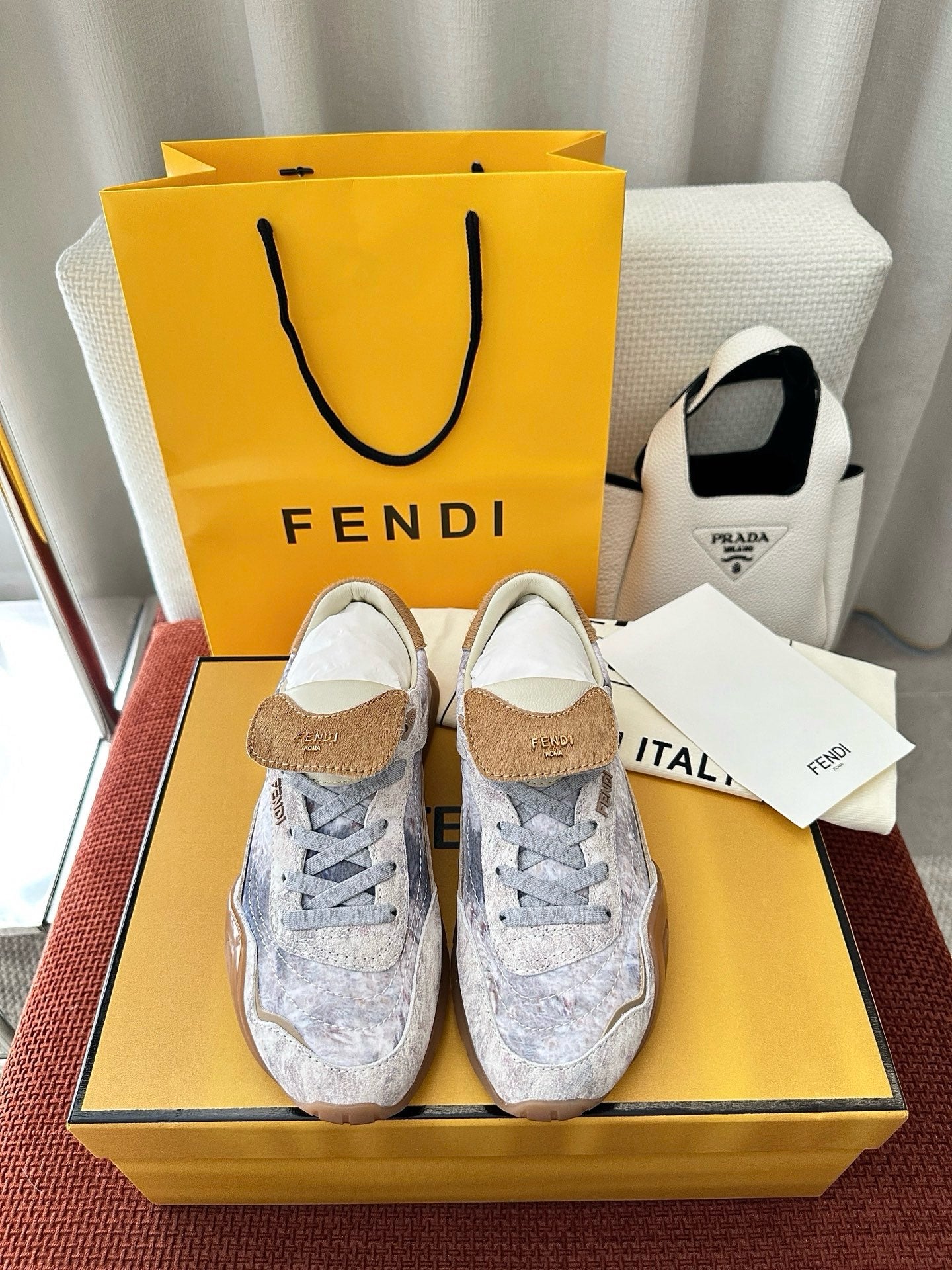 Fendi unisex sneakers in light blue-gray with tan suede heel patches and lace-up front