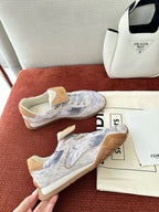 Fendi unisex sneakers with light blue-gray upper and tan suede heel, viewed from above