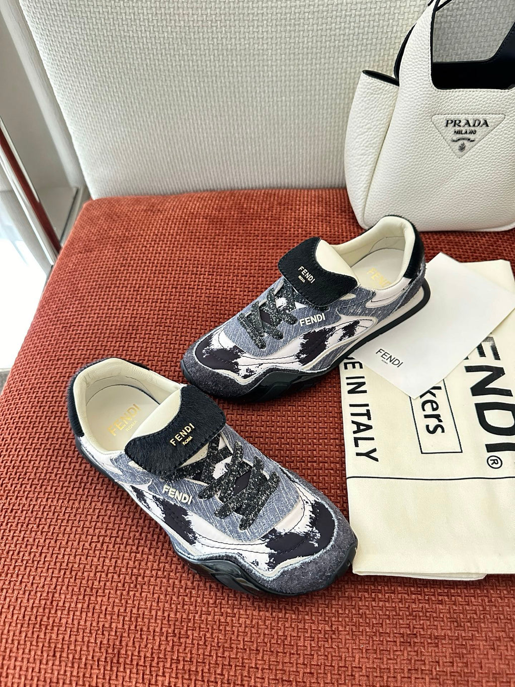 Unisex sneakers top-down view: navy-and-white pattern, lace-up, chunky rubber sole.