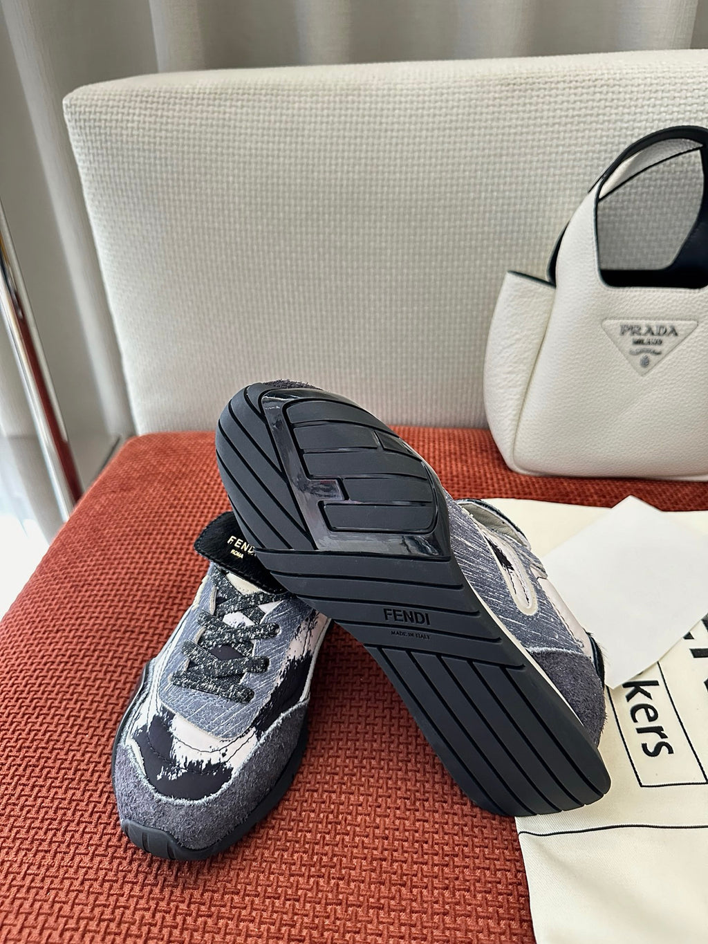 Unisex sneakers with dark blue and white pattern, outsole tread visible, lace-up front.