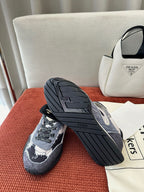Unisex sneakers with dark blue and white pattern, outsole tread visible, lace-up front.