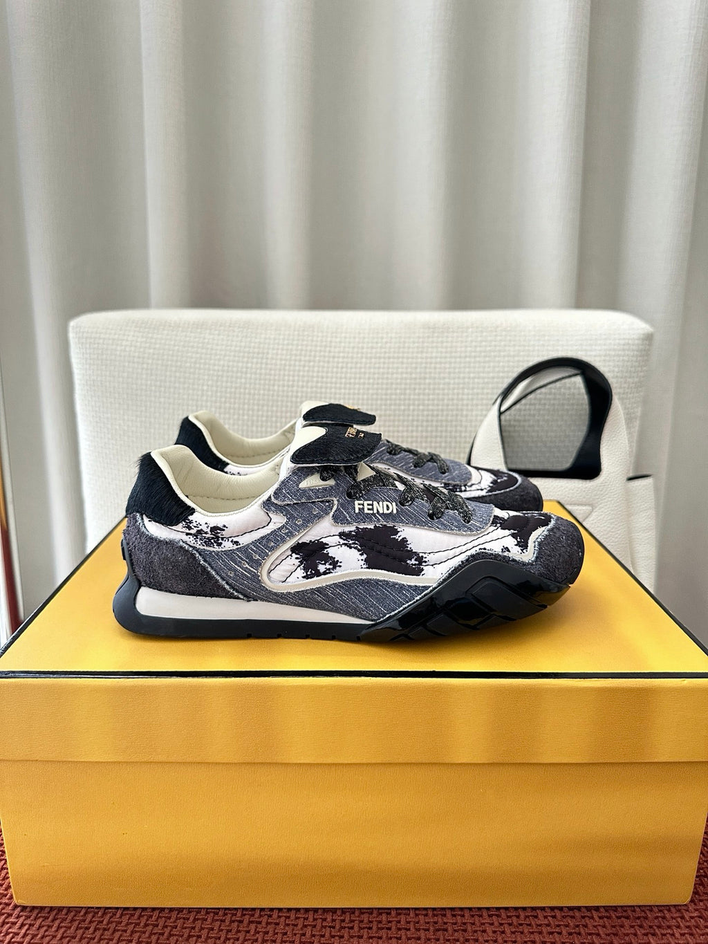 Unisex sneakers with navy-and-white patterned design, lace-up, chunky rubber sole.