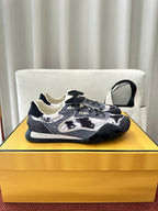 Unisex sneakers with navy-and-white patterned design, lace-up, chunky rubber sole.