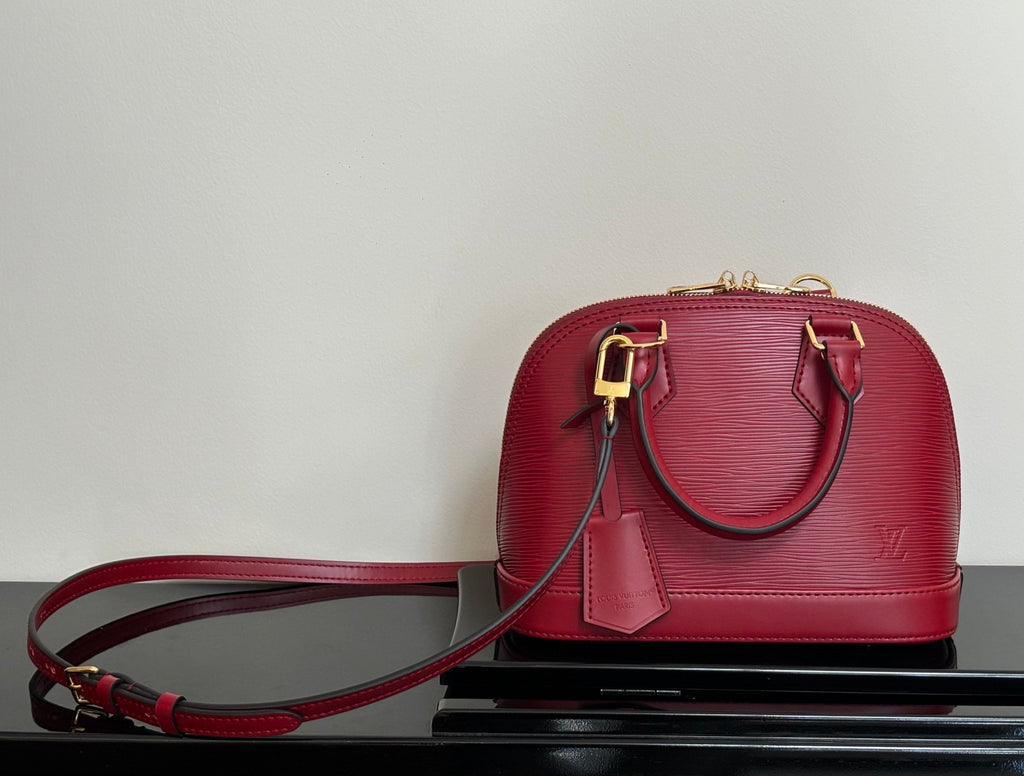 Louis Vuitton red Epi-style handbag with shoulder strap and gold-tone clasps