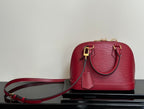 Louis Vuitton red Epi-style handbag with shoulder strap and gold-tone clasps