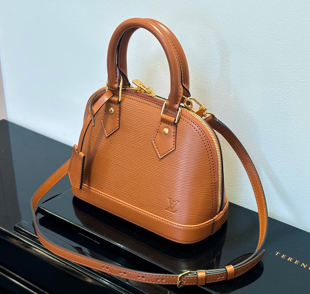 Louis Vuitton tan leather handbag with top handles and crossbody strap