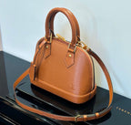 Louis Vuitton tan leather handbag with top handles and crossbody strap
