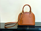 Louis Vuitton tan leather handbag with top handles and crossbody strap