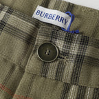 Close-up of plaid pants button and waist label with blue drawstring