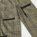 Olive plaid pants with black side pockets and drawstring hem strap
