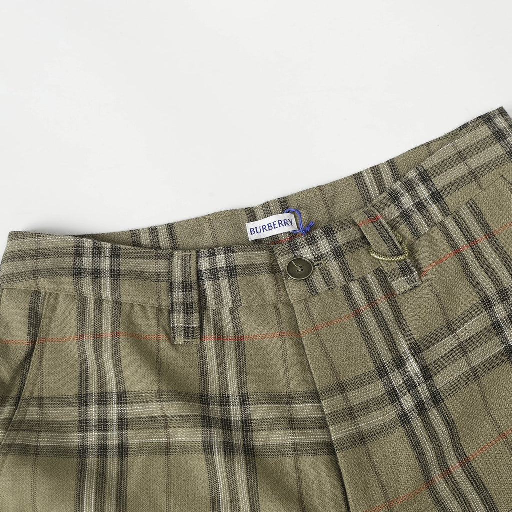 Waistband of olive plaid pants with belt loops, button, and dark side tab