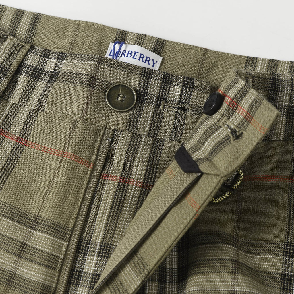 Waistband of plaid pants with button closure and stitched drawstring channel