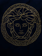 Gold Medusa emblem on black Versace bomber jacket back