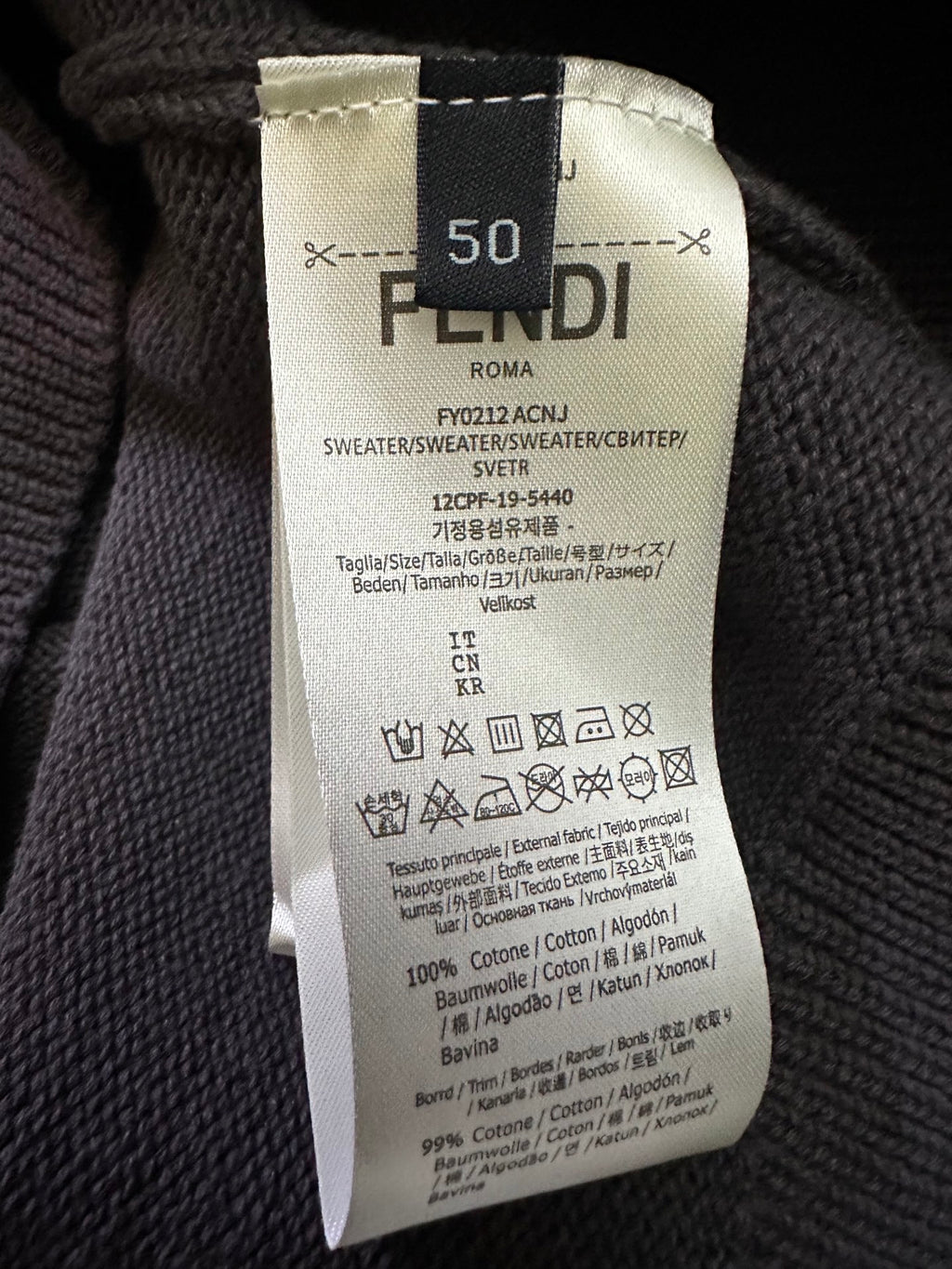 Fendi clothing care label on dark gray knit sweater, size 50
