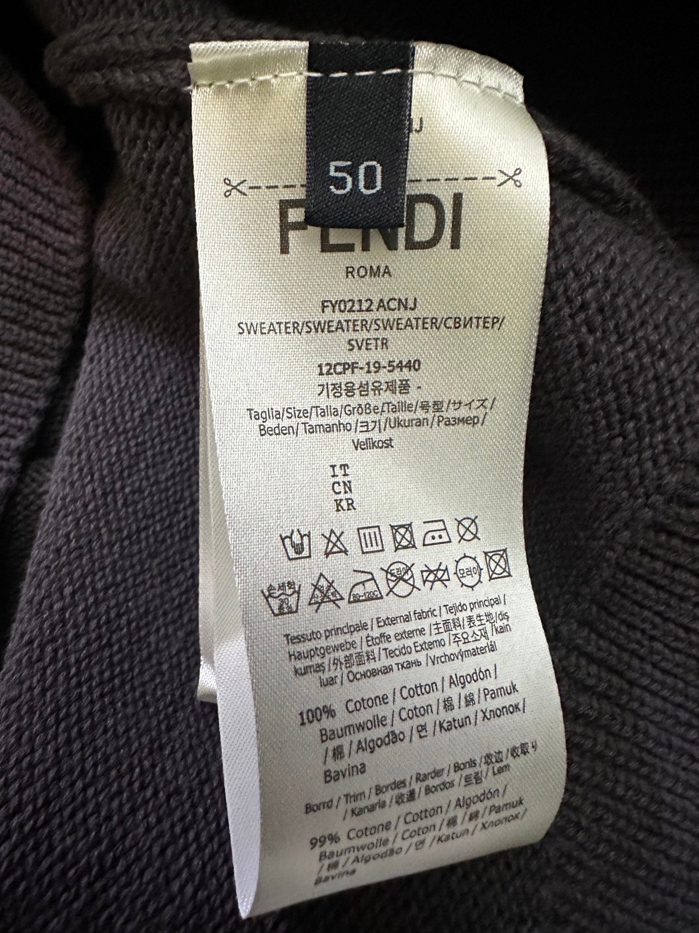 Fendi clothing care label on dark gray knit sweater, size 50