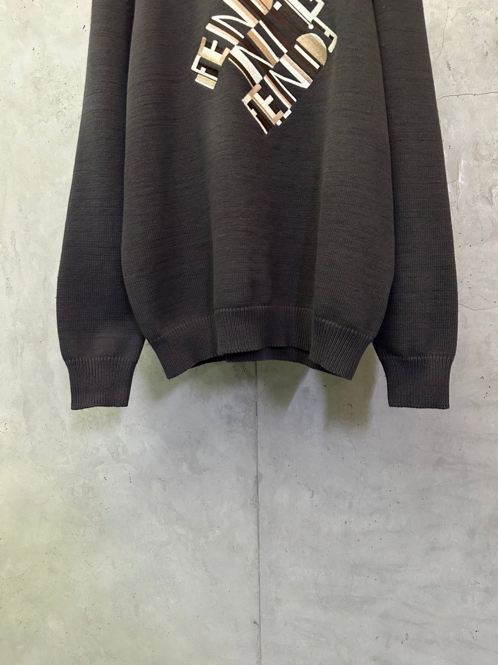 Long-sleeve knit sweater hem and cuffs detail, dark gray