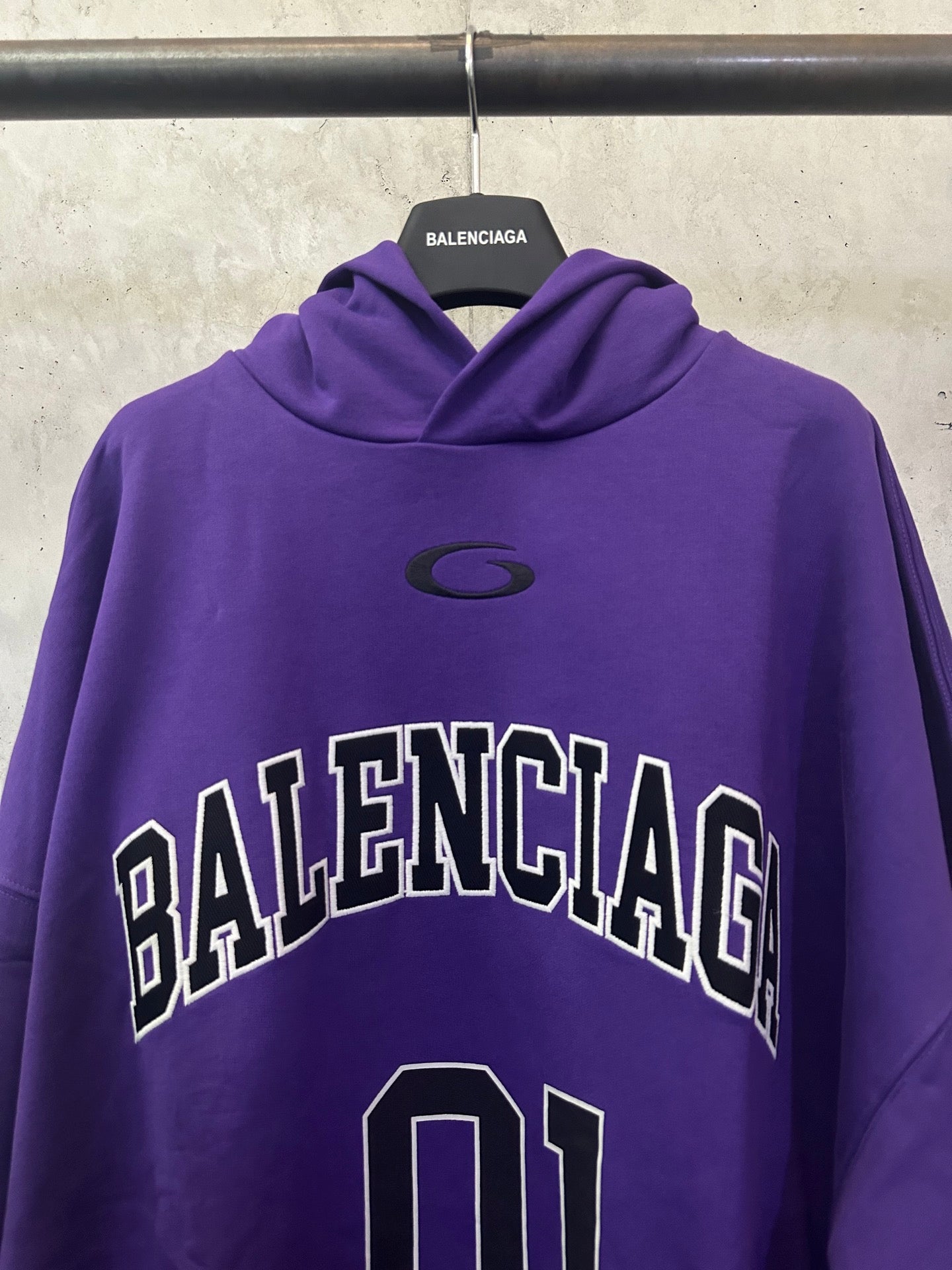 Purple Balenciaga hoodie with chest 'BALENCIAGA' logo and small oval emblem