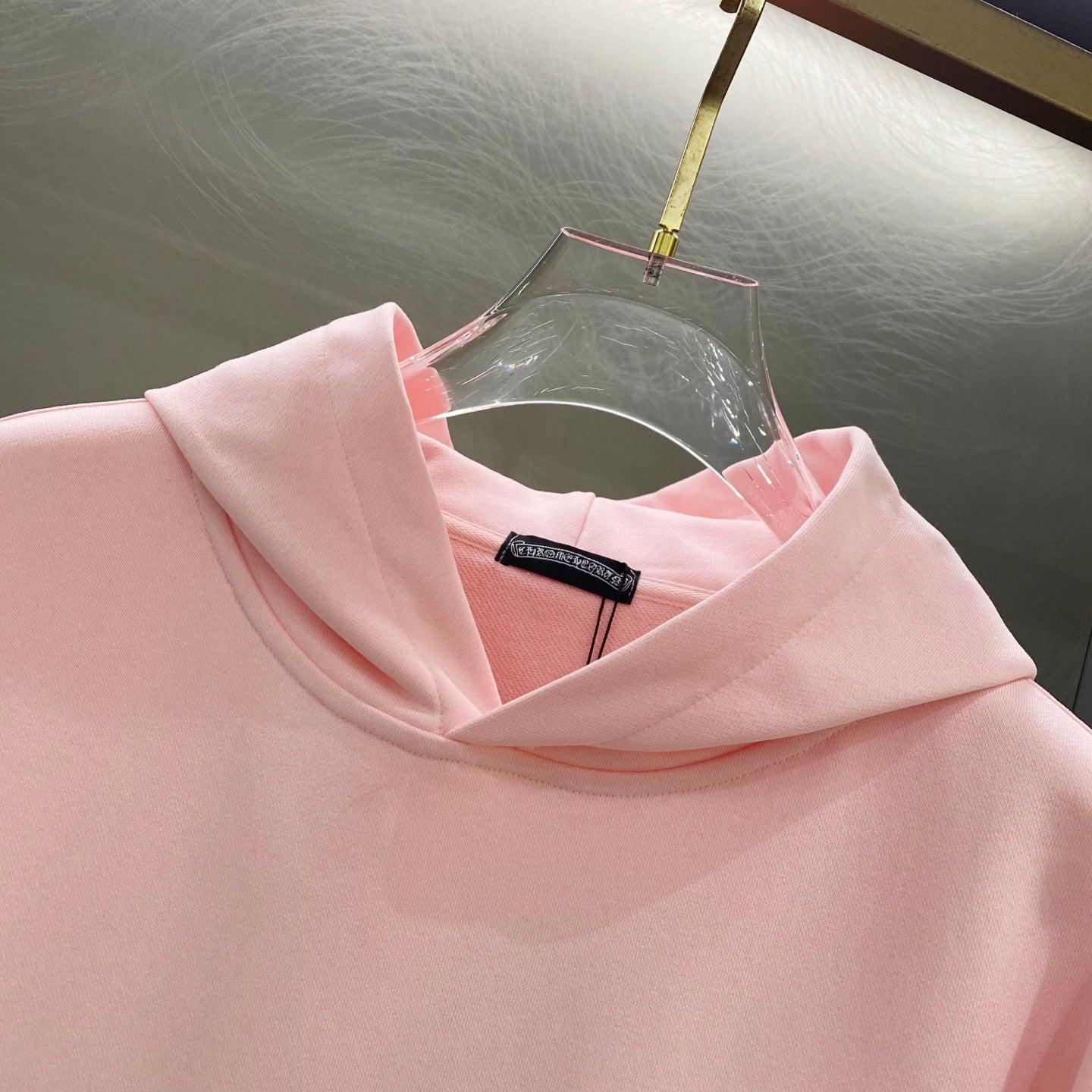 Pink hoodie hood and neckline with small interior brand label