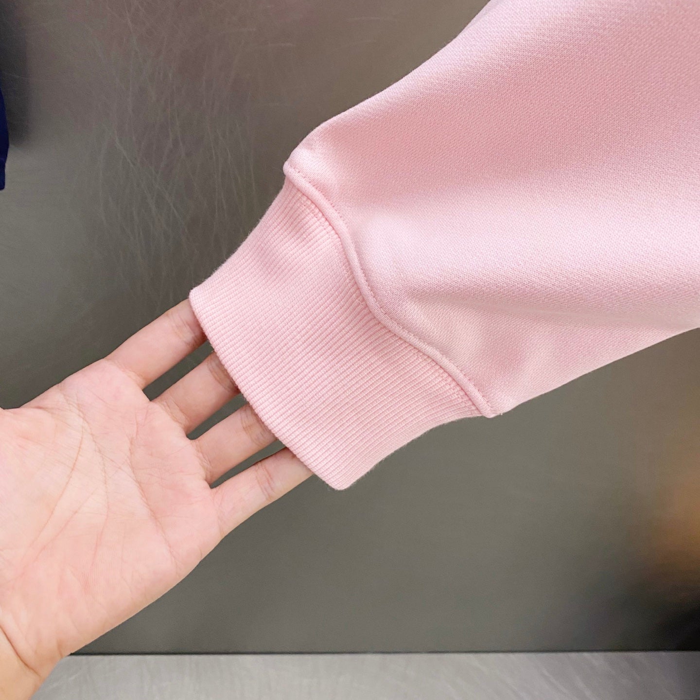 Pink hoodie sleeve cuff with ribbed knit hem