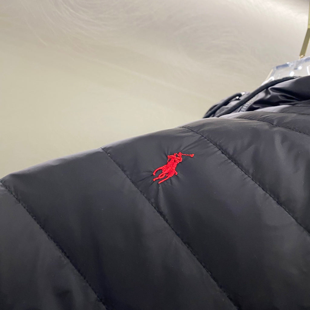 Navy quilted jacket with red embroidered logo on upper sleeve