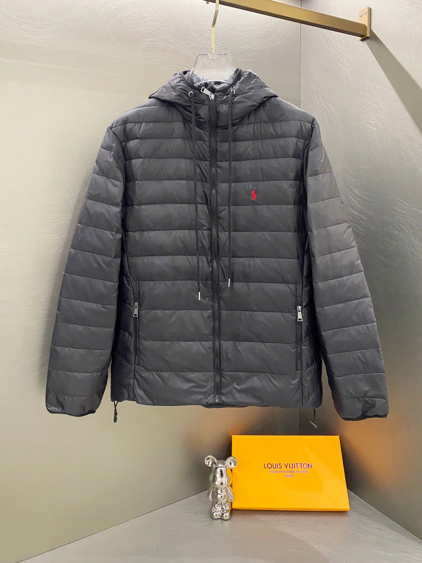 Dark gray quilted hooded jacket with full zip and drawstring hem