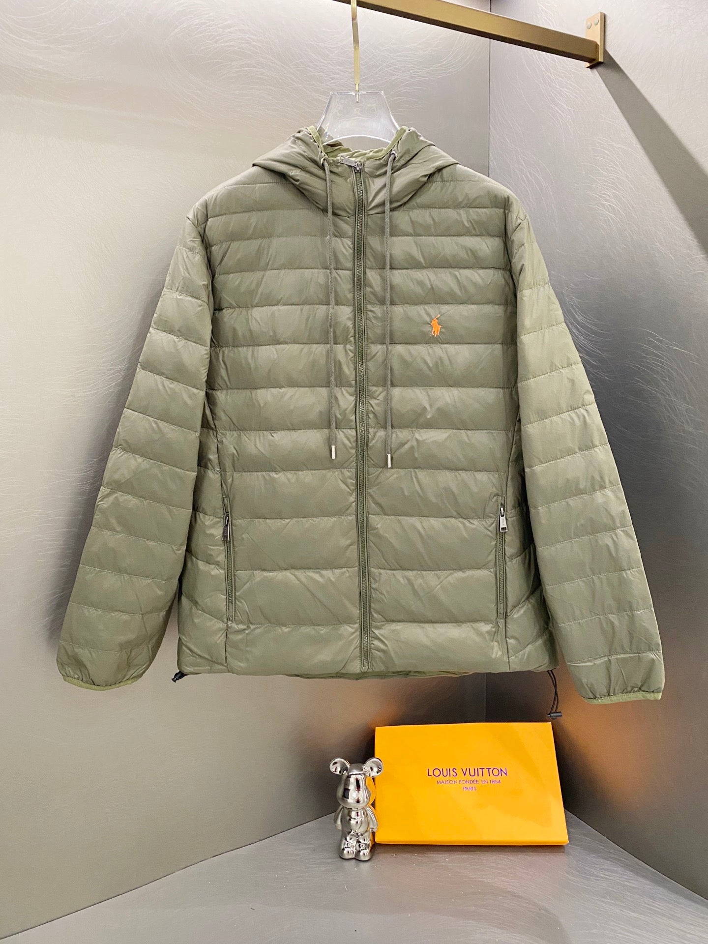 Light green quilted hooded jacket with full zip and drawstring hem