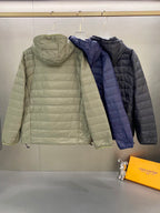 Light green and navy quilted hooded jackets with full zips and drawstring hems