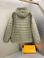Light green quilted hooded jacket back view with full zip and drawstring hem