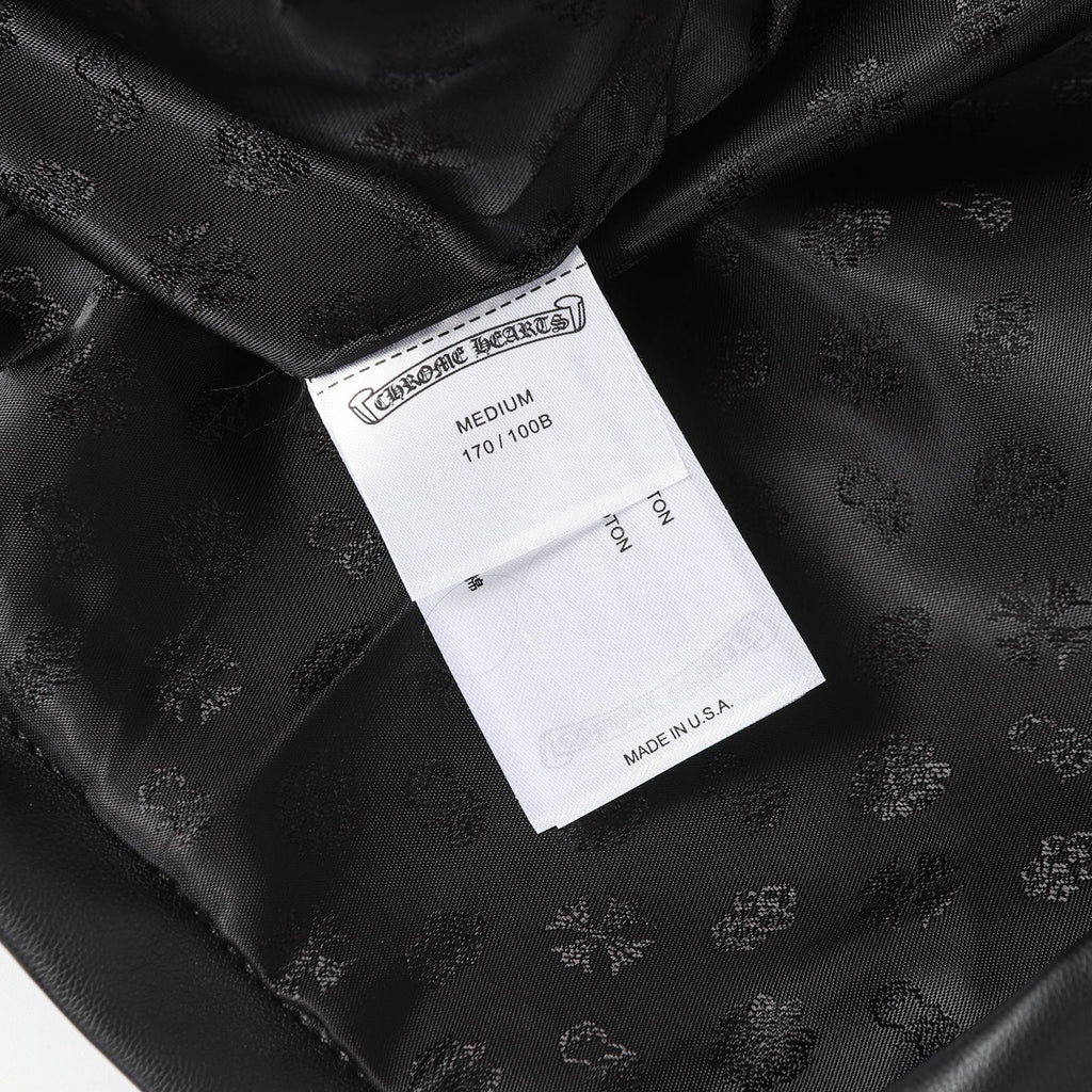Black long pants with interior size label and woven embossed fabric texture