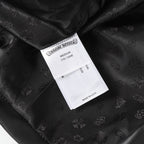 Black long pants with interior size label and woven embossed fabric texture