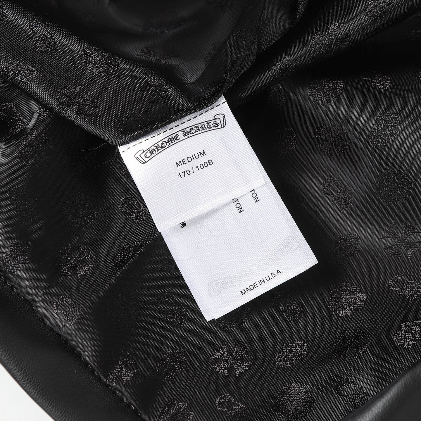 Black long pants with interior size label and woven embossed fabric texture