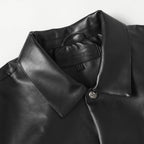 Black leather jacket collar with snap button and embossed chest patch detail