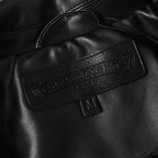 Black leather jacket neckline with inner label and snap detail
