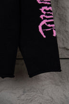 Black sweatshirt lower sleeve with purple vertical “Chrome Records” lettering