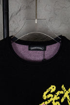 Black long-sleeve sweatshirt neckline with purple check inner collar and neck tag