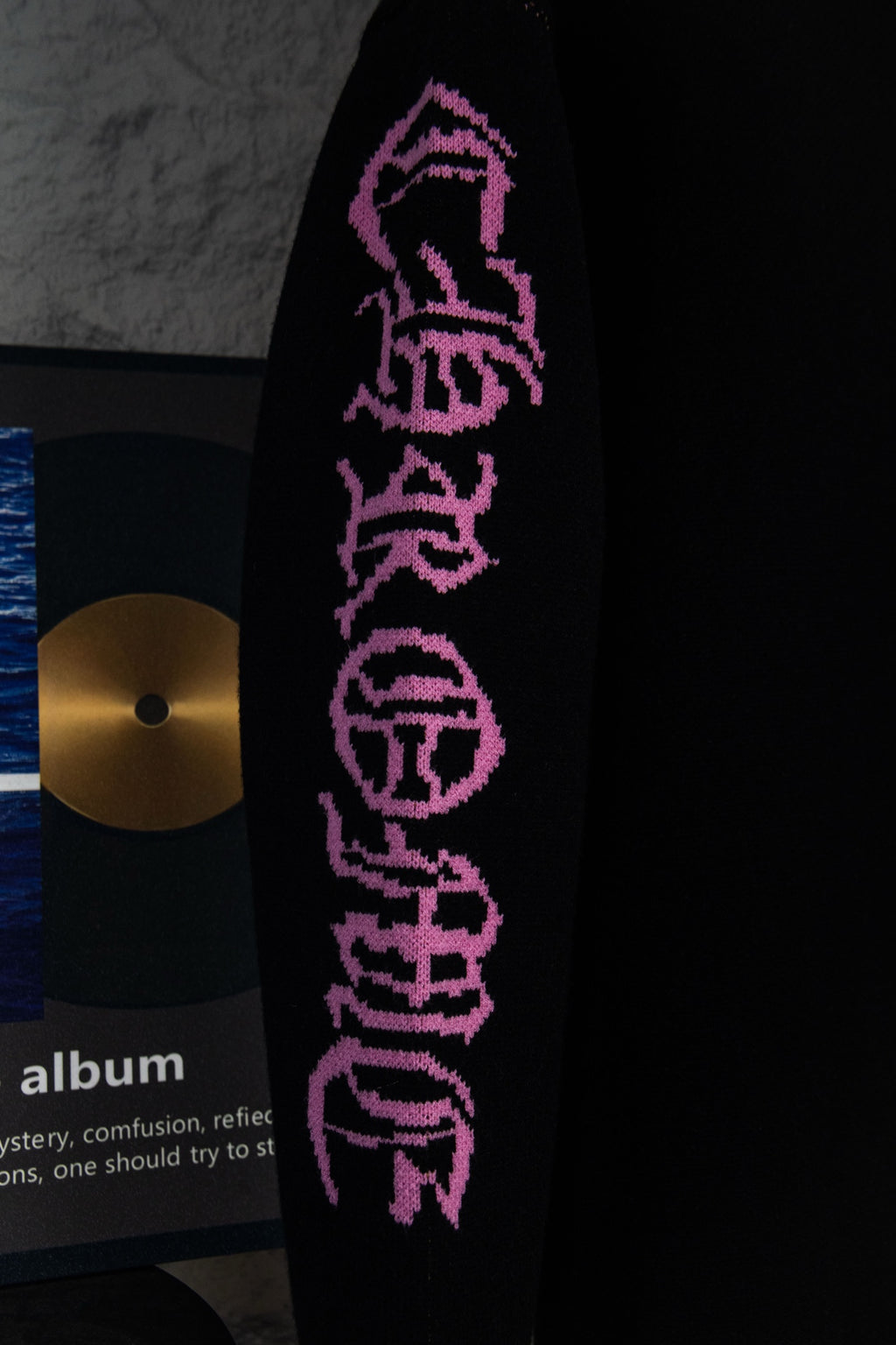 Black sweatshirt sleeve with purple vertical “Chrome Records” lettering graphic