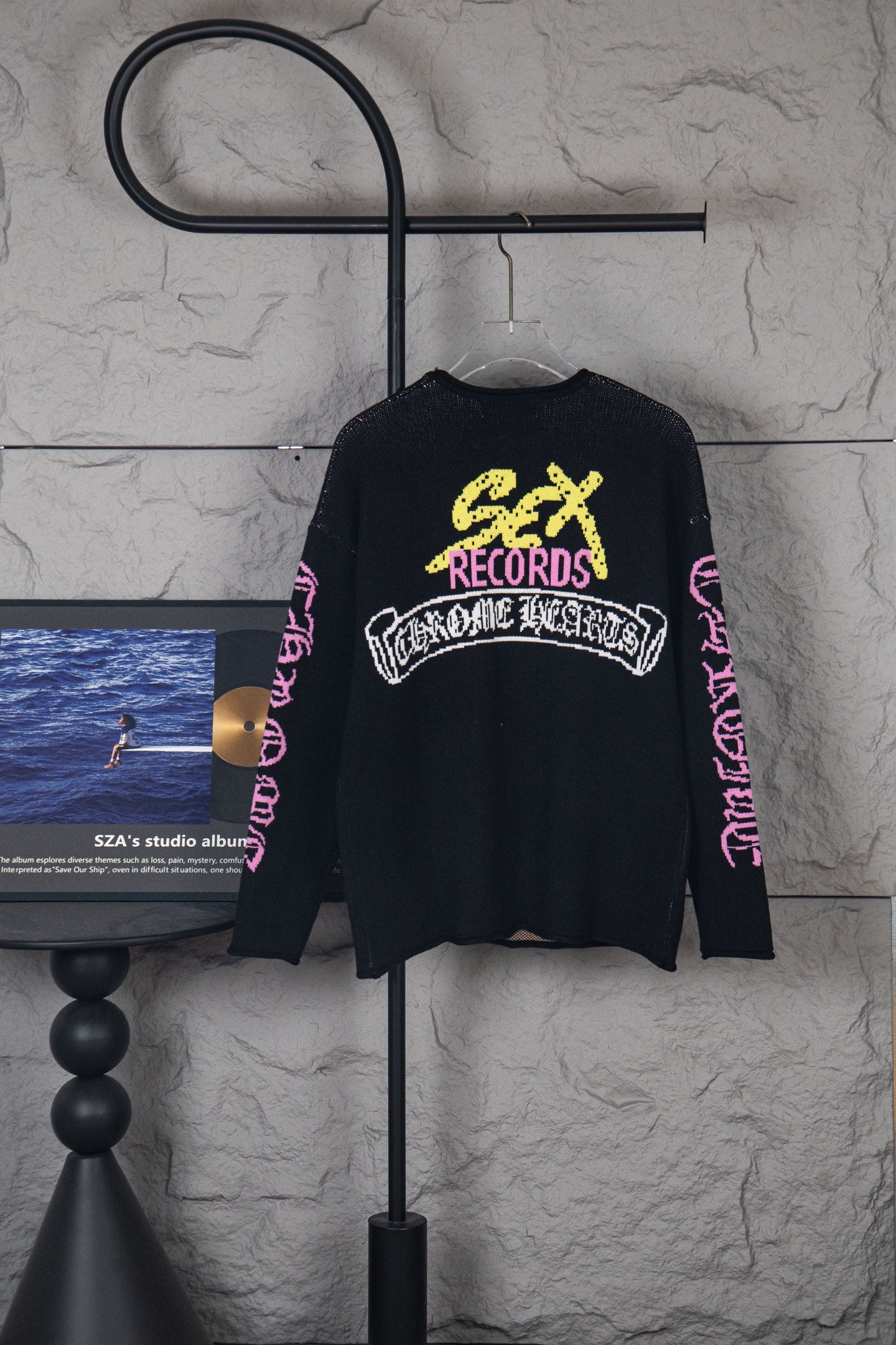 Black long-sleeve sweatshirt back with yellow “Chrome Records” logo and pink sleeve print