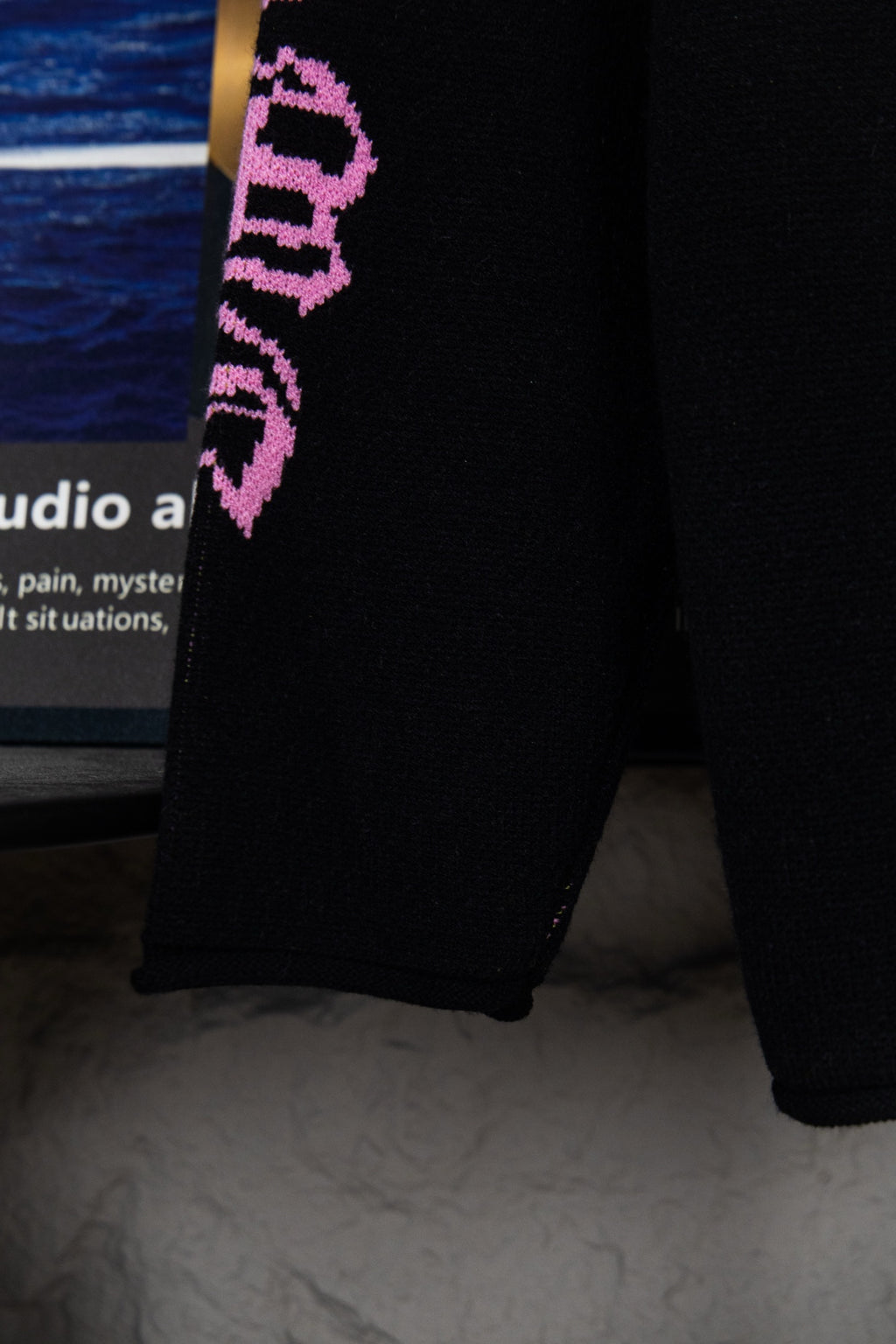 Black sweatshirt sleeve cuff with purple vertical “Chrome Records” lettering