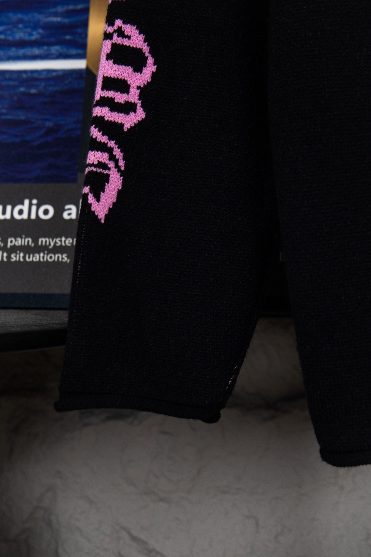 Black sweatshirt sleeve cuff with purple vertical “Chrome Records” lettering