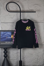 Black long-sleeve sweatshirt with yellow “Chrome Records” graphic and pink sleeve text
