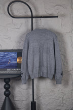 Gray long-sleeve knit sweater back view on hanger, crew neck and ribbed hem