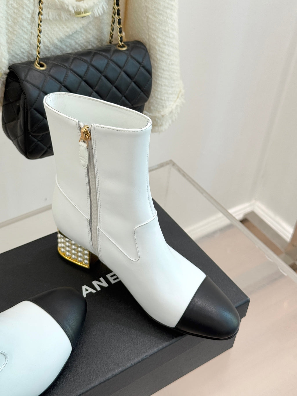 White ankle boots with black panels, stacked heel with gold stud trim