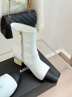 White ankle boots with black panels, stacked heel with gold stud trim