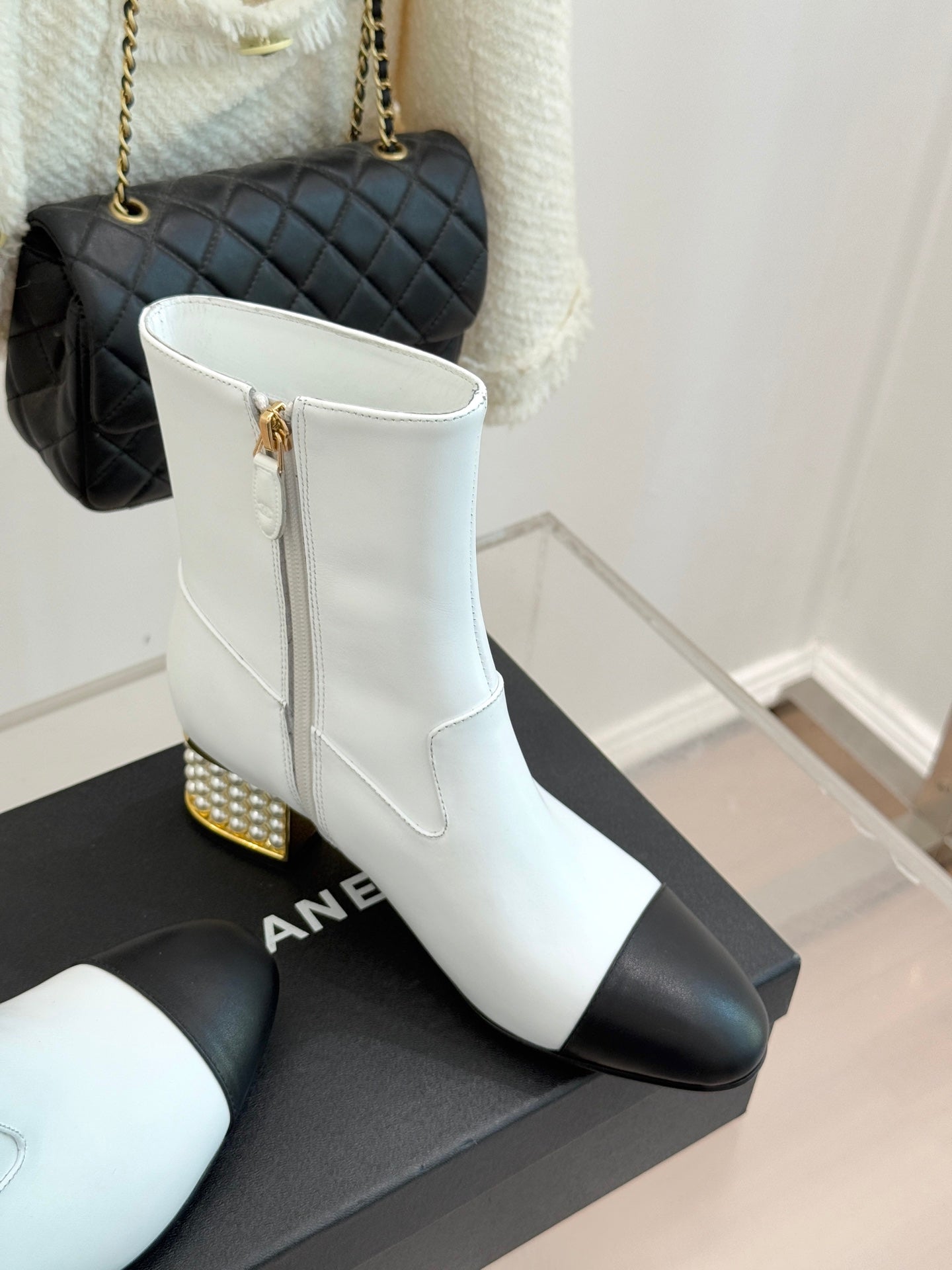 White ankle boots with black panels, stacked heel with gold stud trim